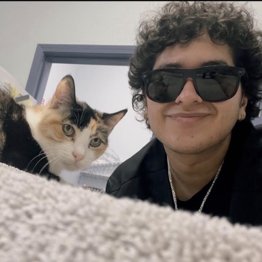 Jose, veterinary assistant at Best Friends Pet Hospital, with Witchy the clinic cat